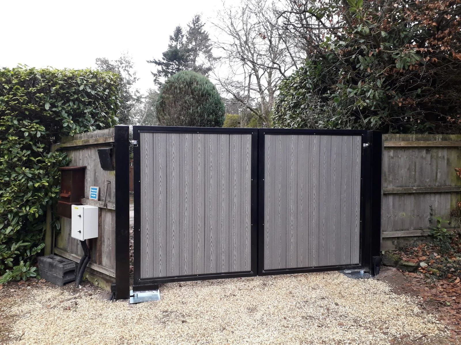 A gate that is in the middle of a yard.