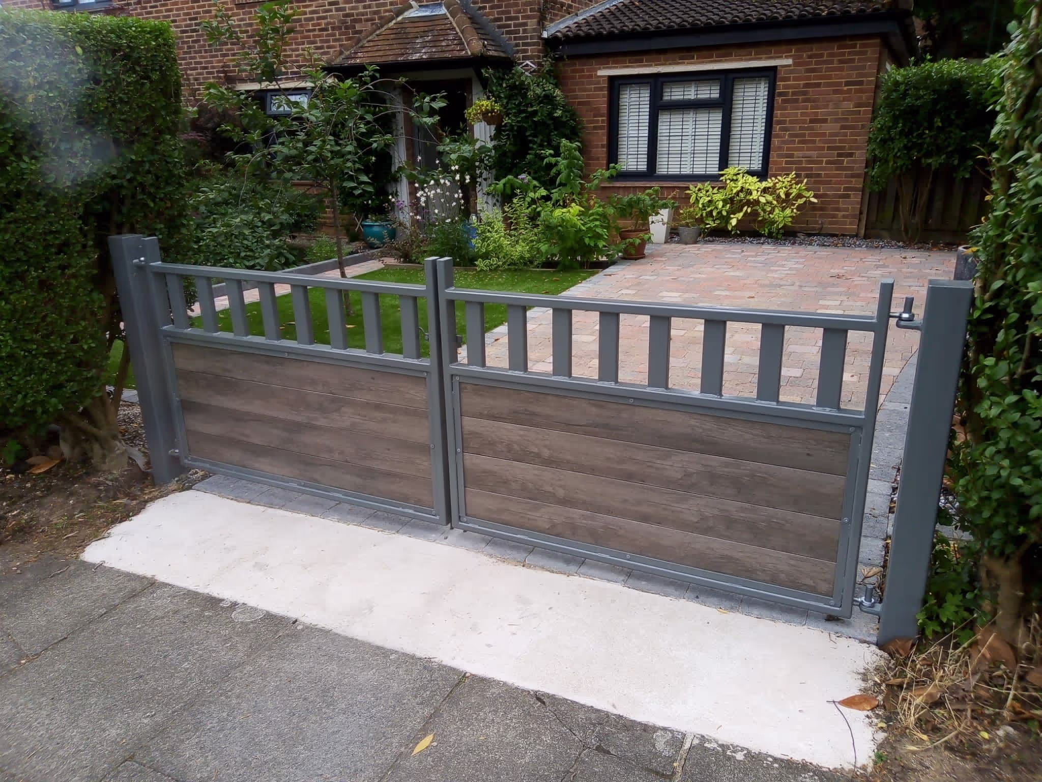 A house with a driveway and a gate in front of it.