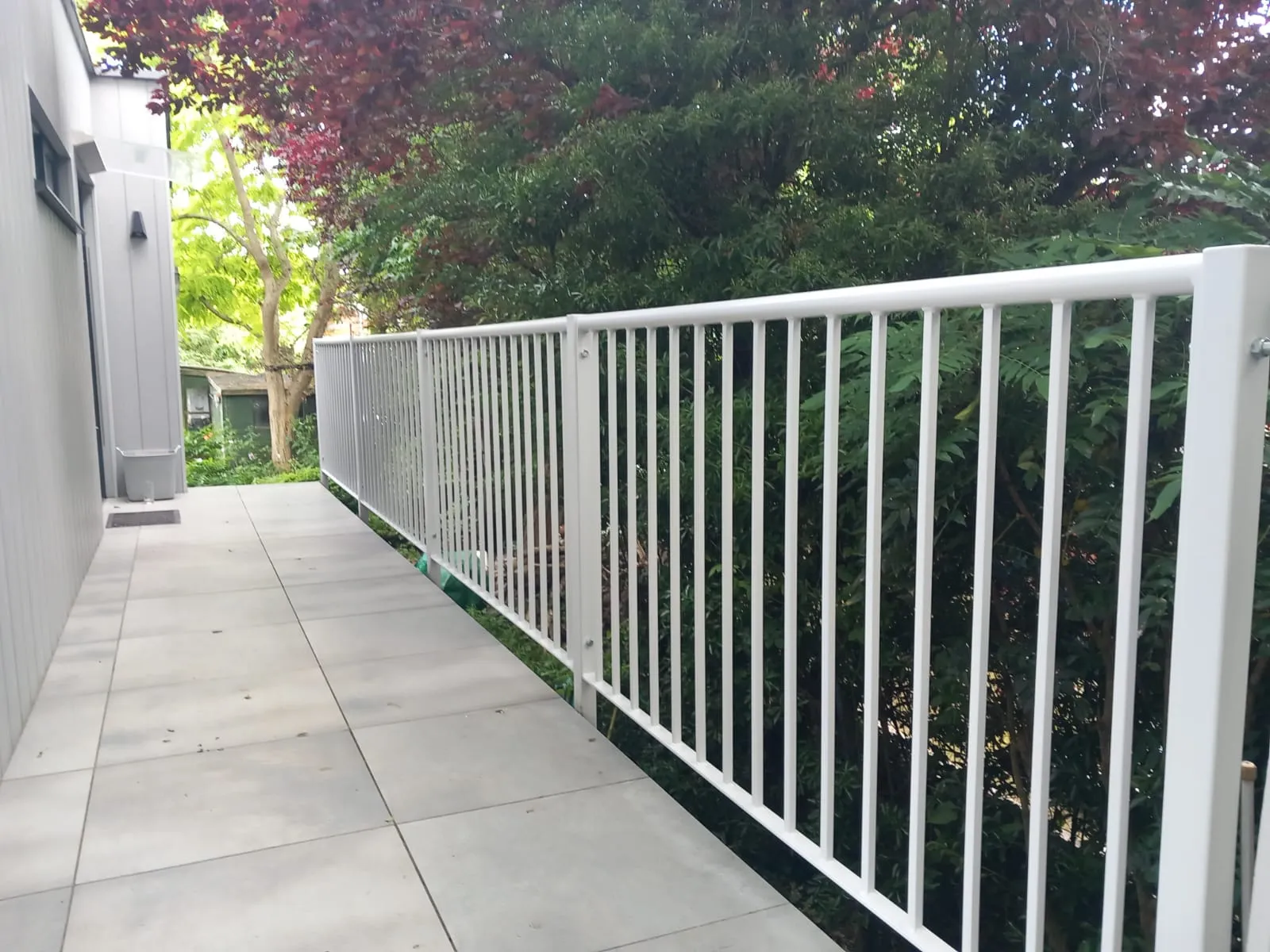 A white railing on the side of a building.