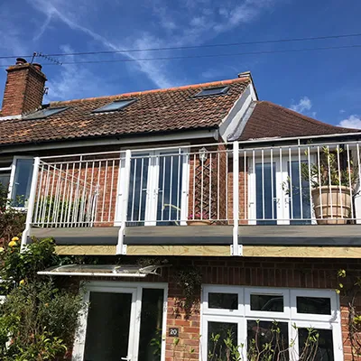 a house with a balcony and a balcony railing